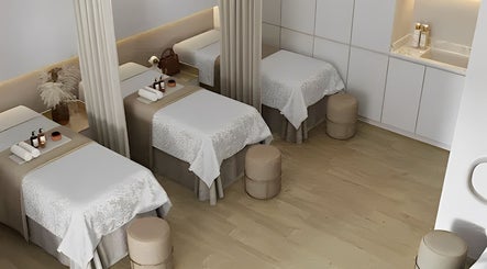 Cozy spa room at The Lash House, Singapore, SG with three massage beds and ambient lighting.