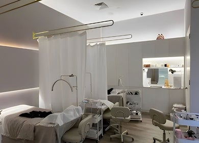 Elegant treatment room at The Lash House, Singapore, SG, featuring cozy beds with modern lighting.
