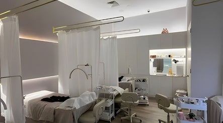 Elegant treatment room at The Lash House, Singapore, SG, featuring cozy beds with modern lighting.