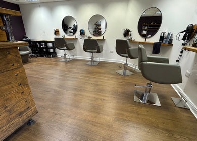 Modern salon interior with stylish chairs at Jesse Jackson Hair in Cudworth, England, GB.