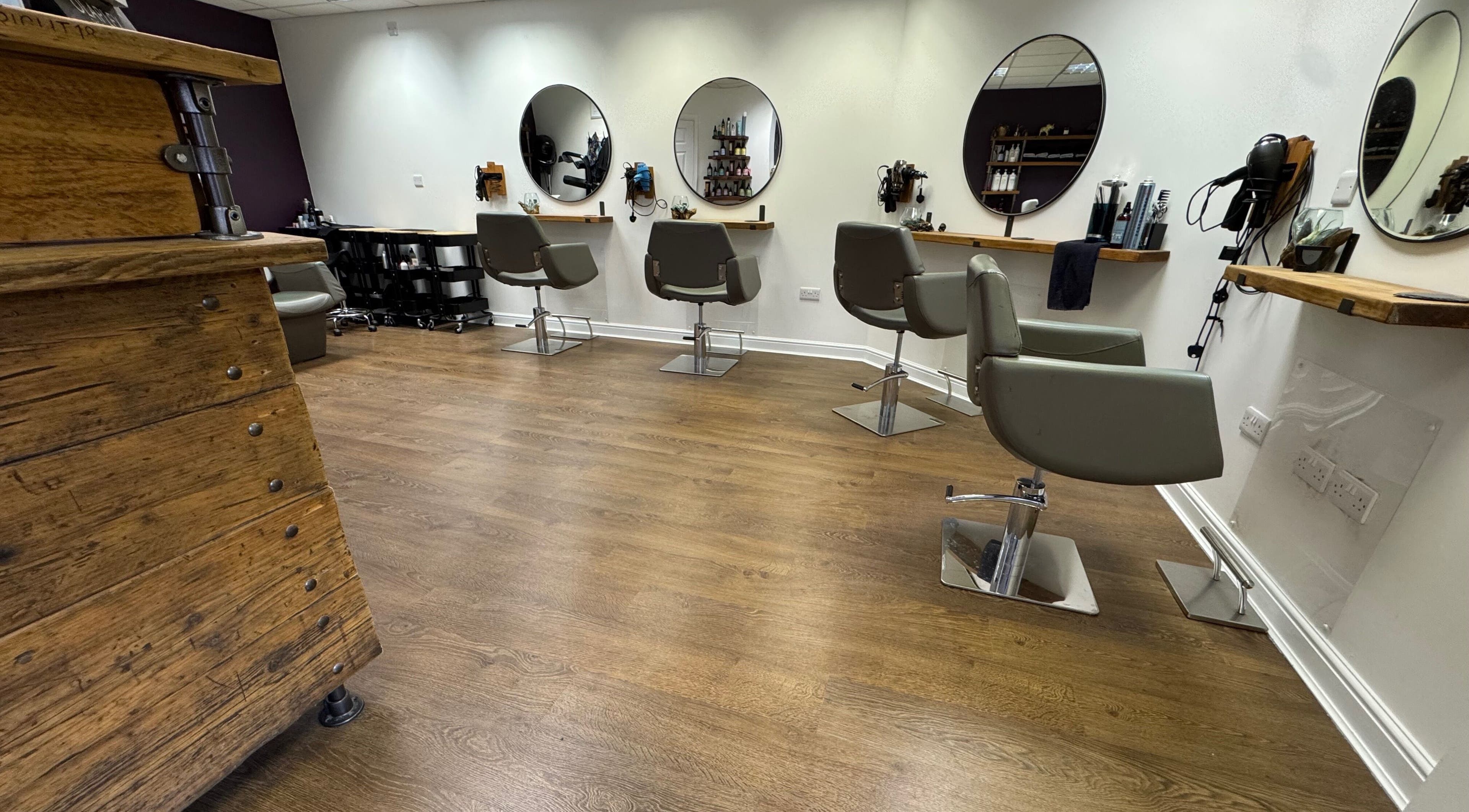 Beautiful interior of Jesse Jackson Hair in Cudworth, England with stylish mirrors and chairs.
