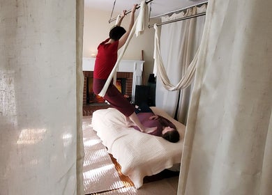A practitioner performs aerial yoga therapy at Active Healing Dallas FT Worth in Watauga, Texas, US.