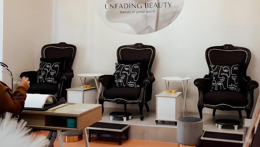 Sophisticated lounge area at Unfading Beauty, Gqeberha, Eastern Cape, ZA, showcasing elegant black armchairs.