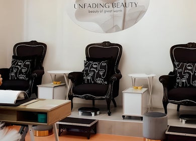 Sophisticated lounge area at Unfading Beauty, Gqeberha, Eastern Cape, ZA, showcasing elegant black armchairs.
