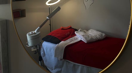 Relaxing spa room at Unfading Beauty, Gqeberha, Eastern Cape, ZA, features massage bed and soft lighting.