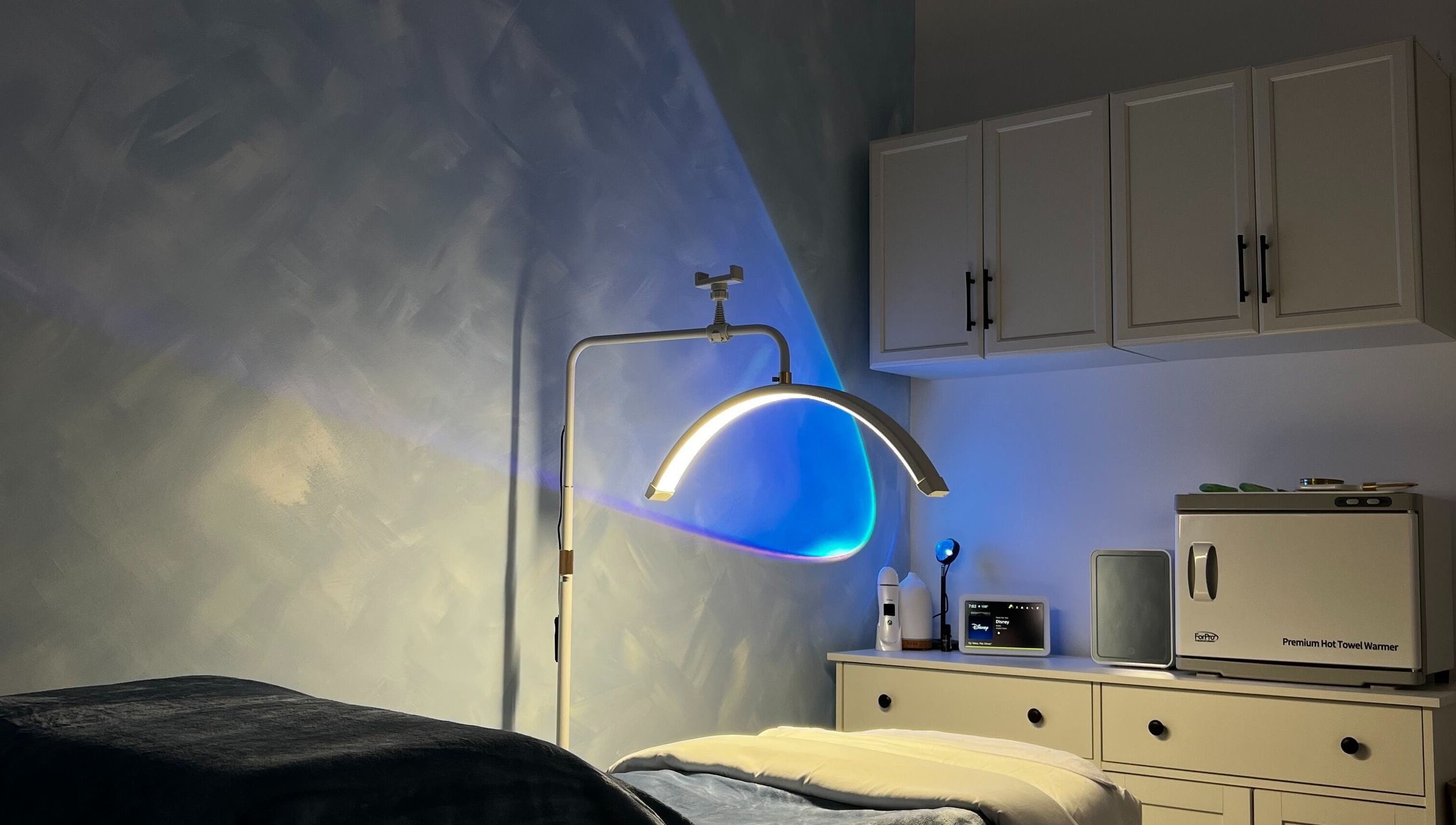 Cozy treatment room at Vice Esthetics, Chandler, Arizona, US, featuring modern lighting and towel warmer.