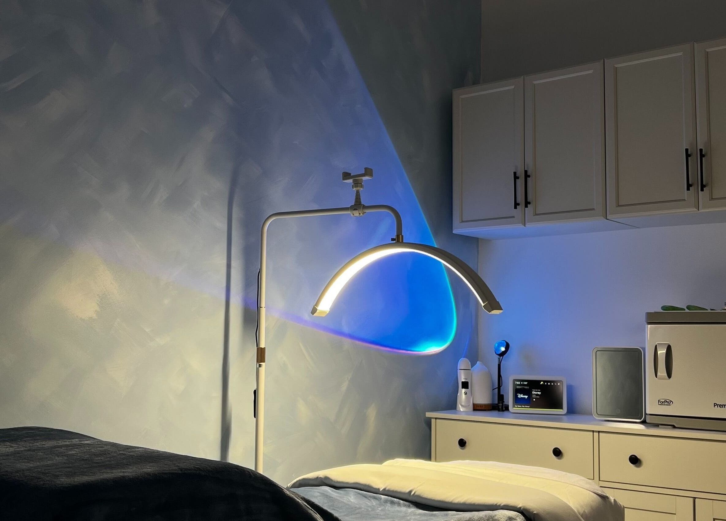 Cozy treatment room at Vice Esthetics, Chandler, Arizona, US, featuring modern lighting and towel warmer.
