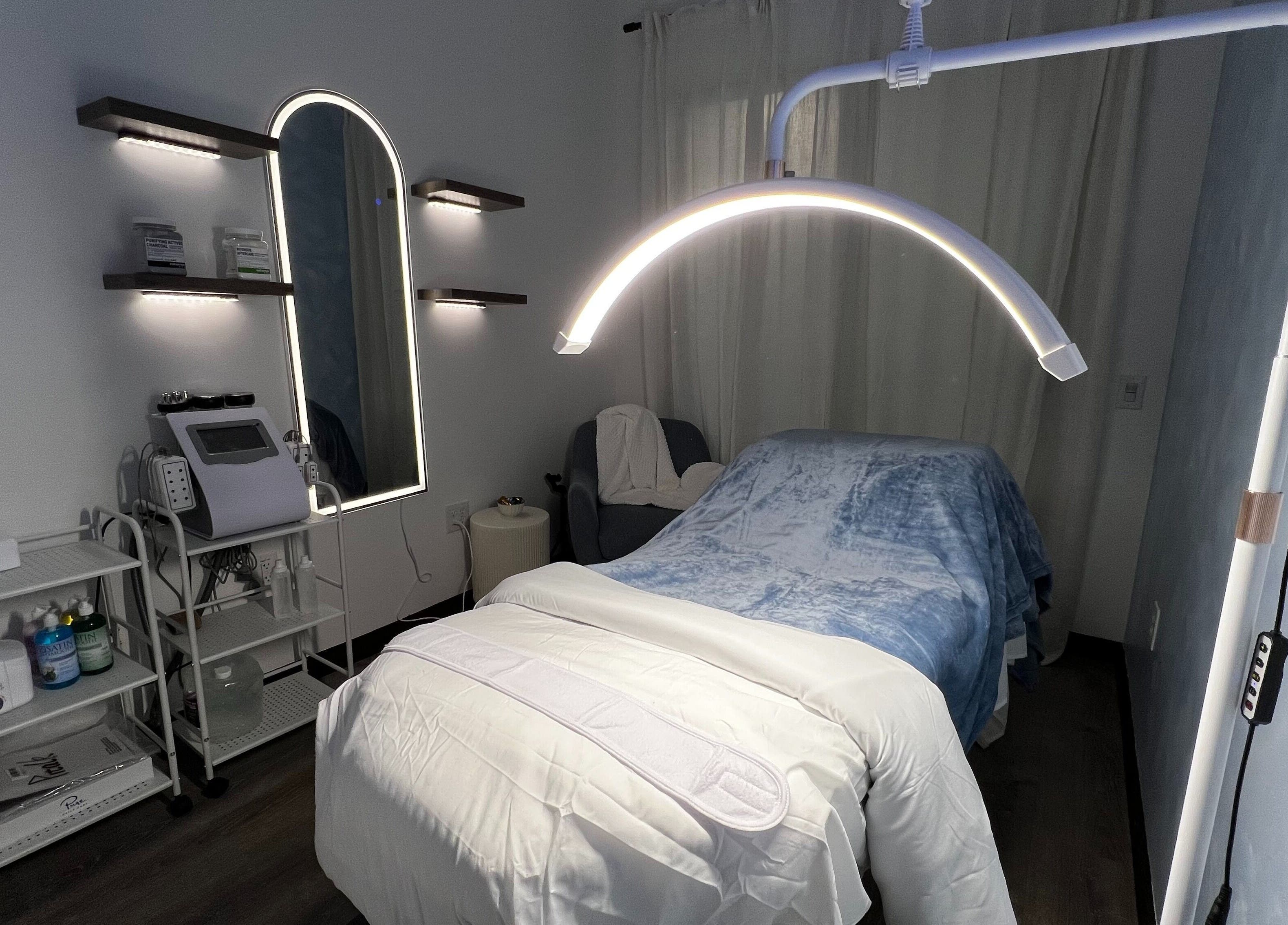 Cozy treatment room at Vice Esthetics, Chandler, Arizona, US, featuring plush bed and modern equipment.