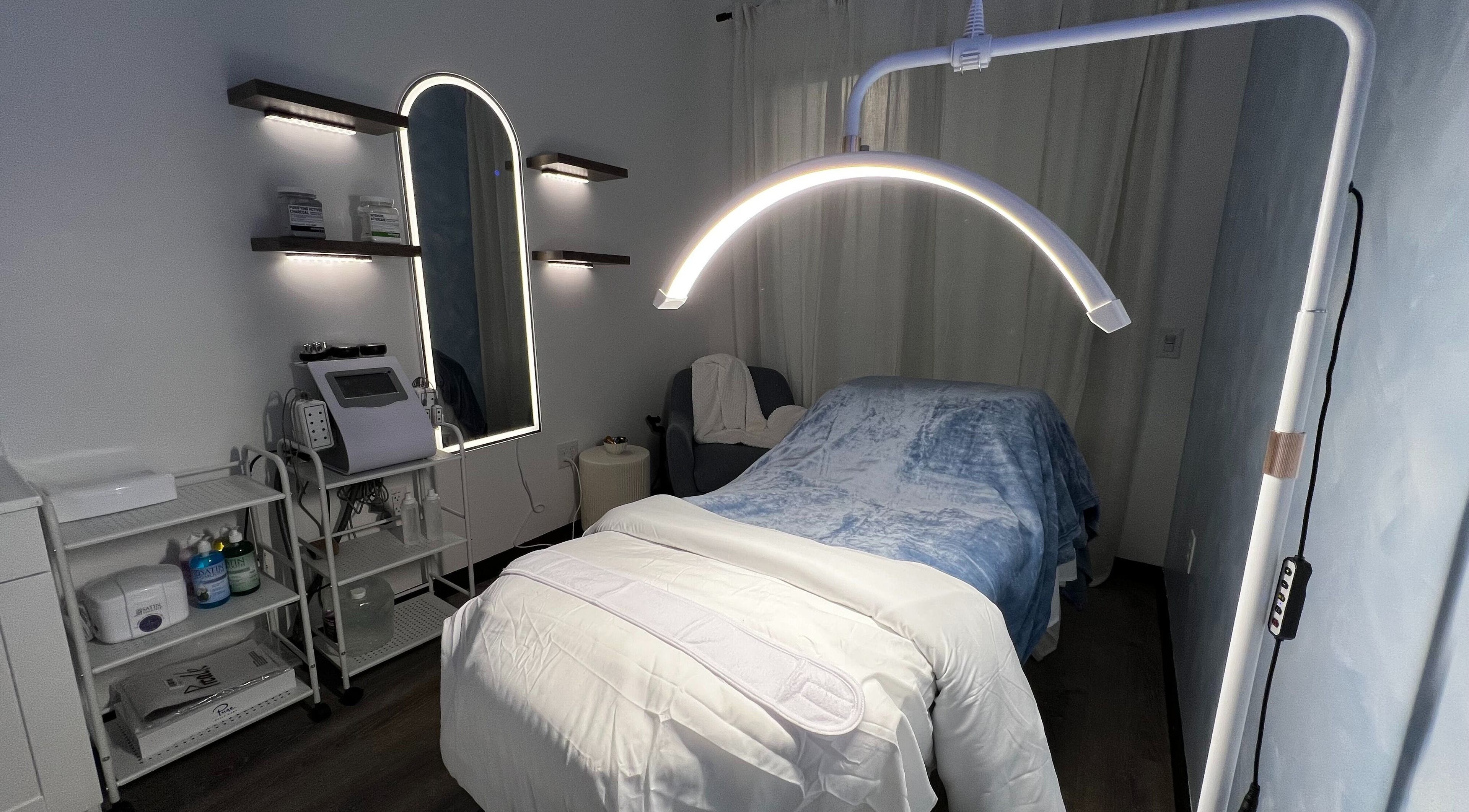 Cozy treatment room at Vice Esthetics, Chandler, Arizona, US, featuring plush bed and modern equipment.