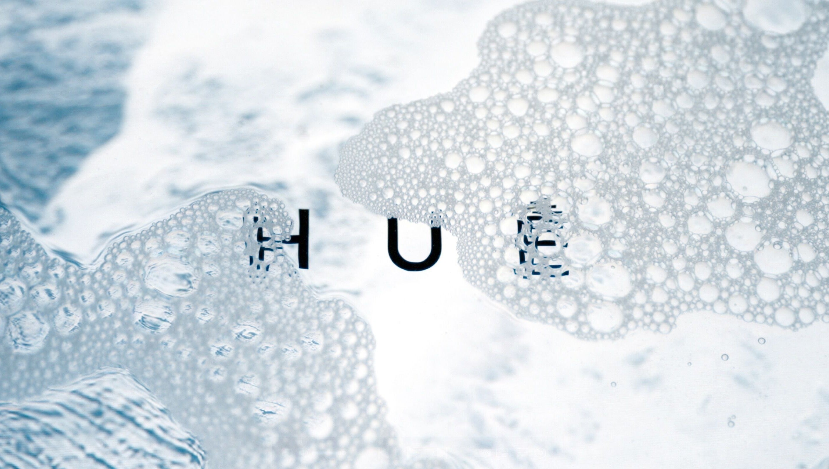 Bubbly texture with HUĒ logo, representing tranquility at HUĒ, London, England, GB.
