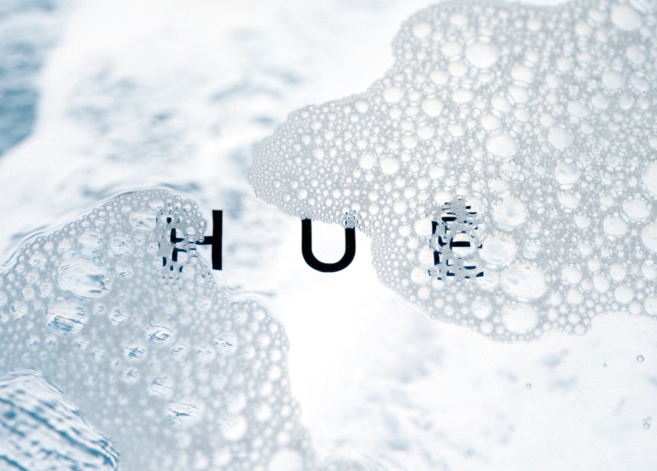 Bubbly texture with HUĒ logo, representing tranquility at HUĒ, London, England, GB.
