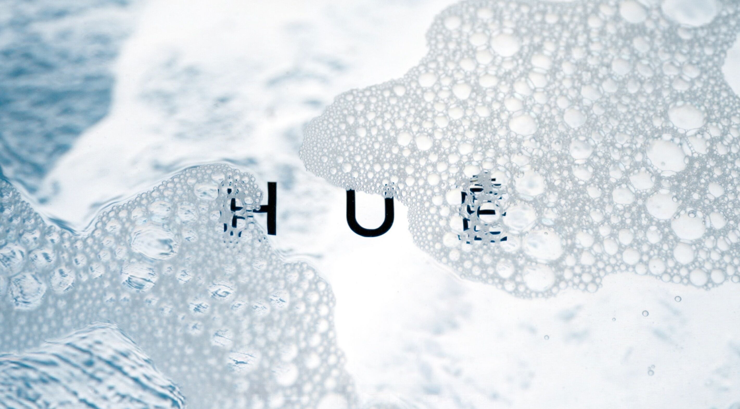 Bubbly texture with HUĒ logo, representing tranquility at HUĒ, London, England, GB.