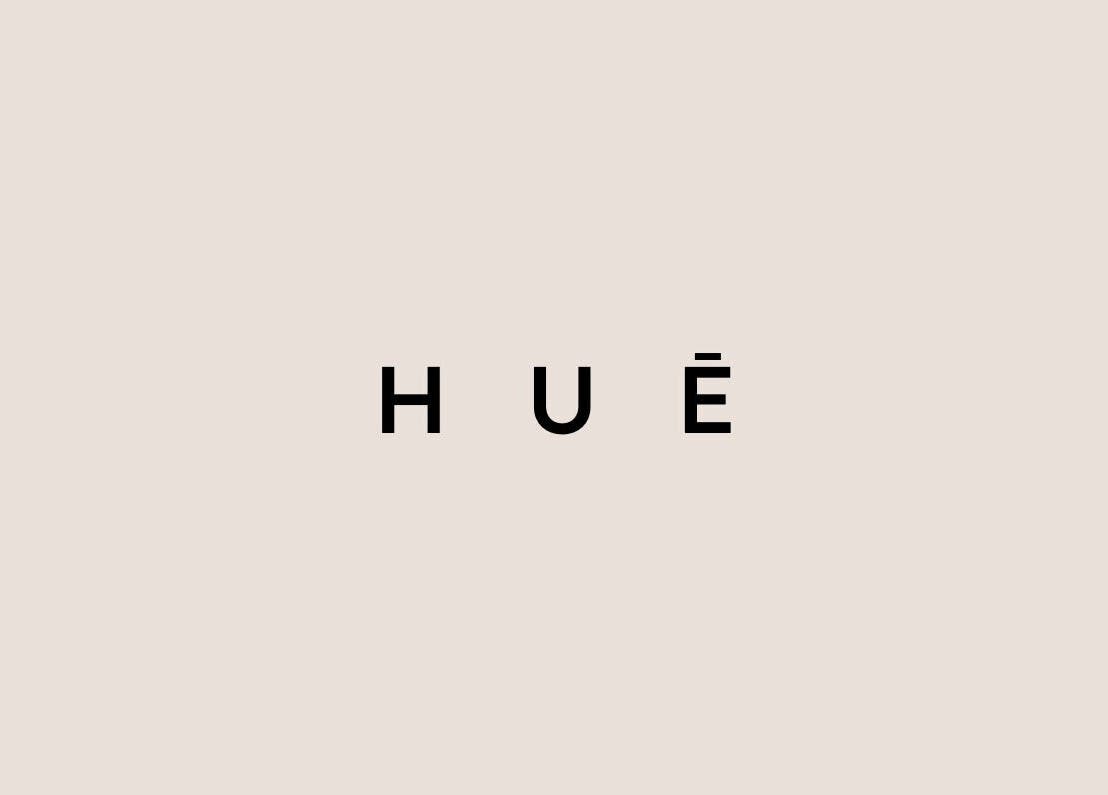HUĒ logo on a beige background, representing the wellness venue in London, England, GB.