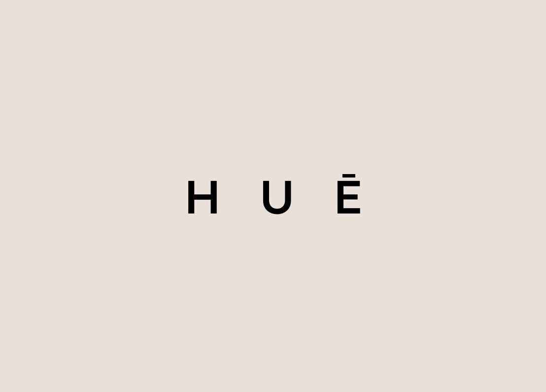 HUĒ logo on a beige background, representing the wellness venue in London, England, GB.