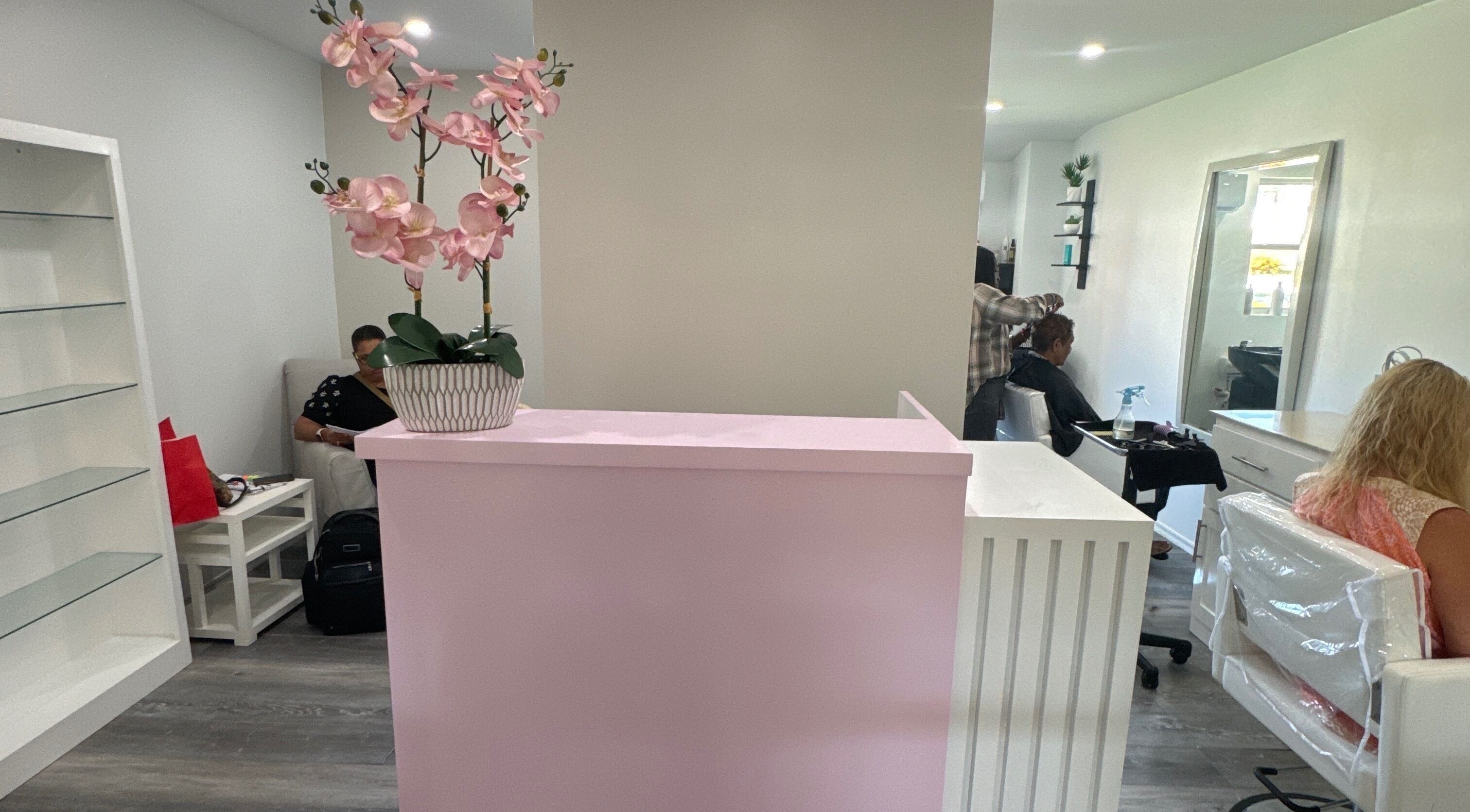 Reception and salon area of Hair By Adriana Montique at Peter, Peter, BB. Bright, chic interior with stylish decor.