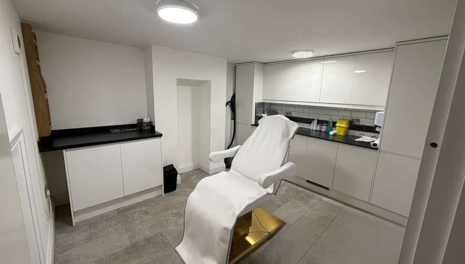 Modern treatment room at Allure Skin & Aesthetics in Sittingbourne, England, GB with a pristine chair and cabinets.
