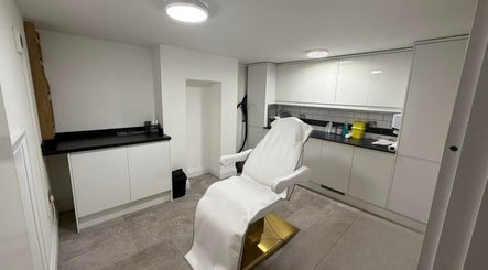 Modern treatment room at Allure Skin & Aesthetics in Sittingbourne, England, GB with a pristine chair and cabinets.