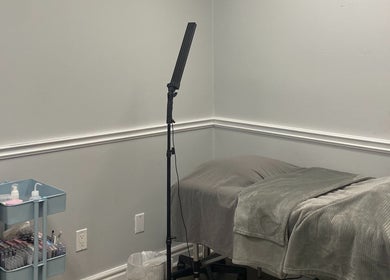 Treatment room at SNR Aesthetics, St. Catharines, Ontario, CA, featuring a cozy bed and beauty essentials.