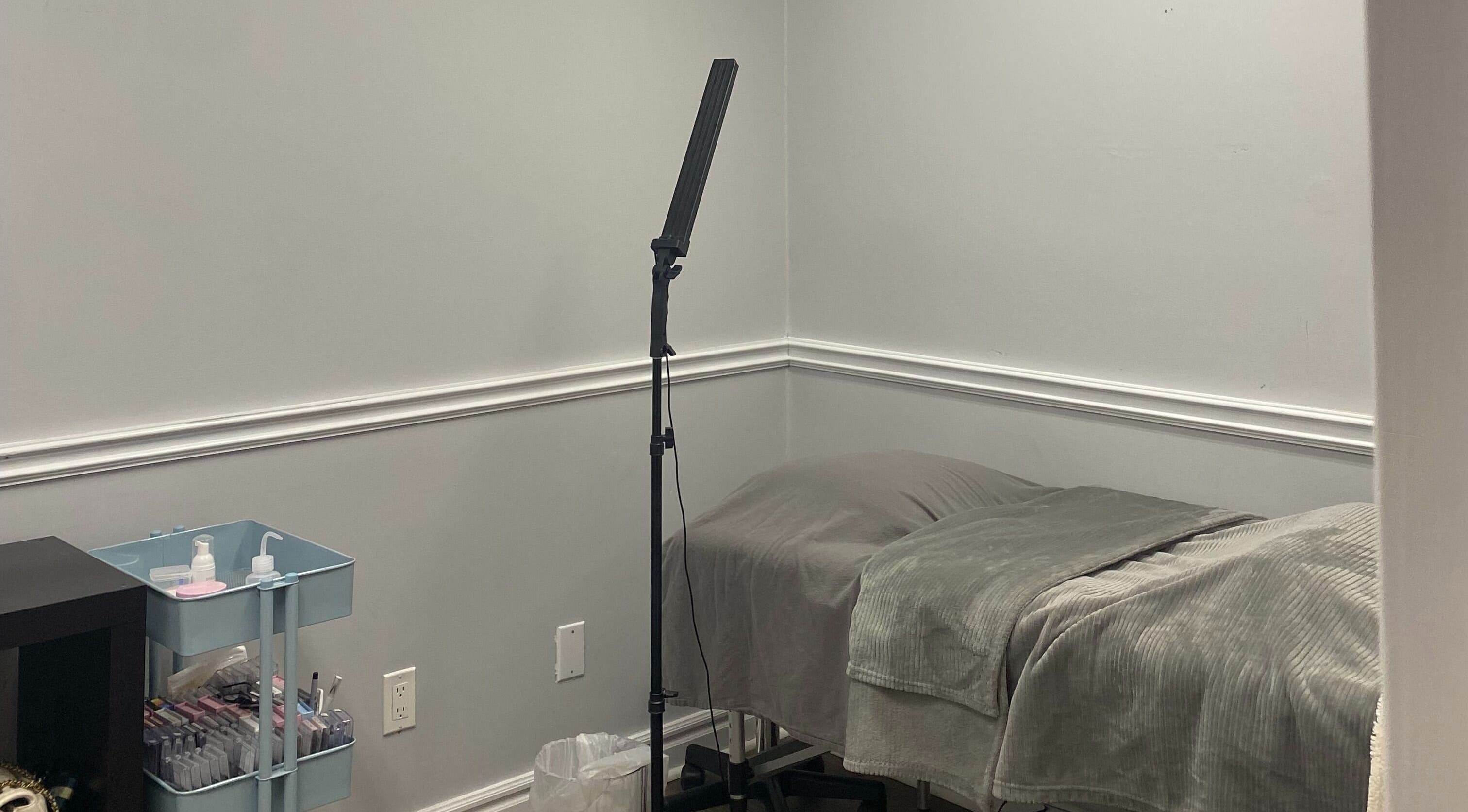 Treatment room at SNR Aesthetics, St. Catharines, Ontario, CA, featuring a cozy bed and beauty essentials.