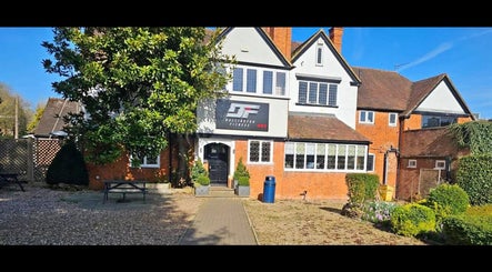 David Charles Hair & Beauty Studio in Northampton, England, GB with lush garden and inviting facade.