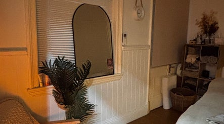 Tranquil treatment room at Roxanne Mae's RMT Maryborough, Queensland, AU with warm lighting and relaxing decor.