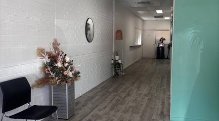 Interior hallway with floral decor at Roxanne Mae's RMT Torquay, Queensland, AU, offering a tranquil ambiance.