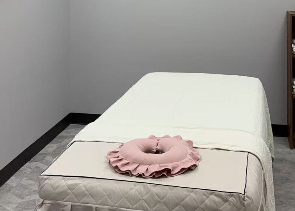 Cozy massage room at You You Spa in Saint Paul, Minnesota, US with inviting table and towels.