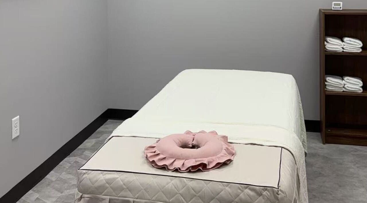 Cozy massage room at You You Spa in Saint Paul, Minnesota, US with inviting table and towels.