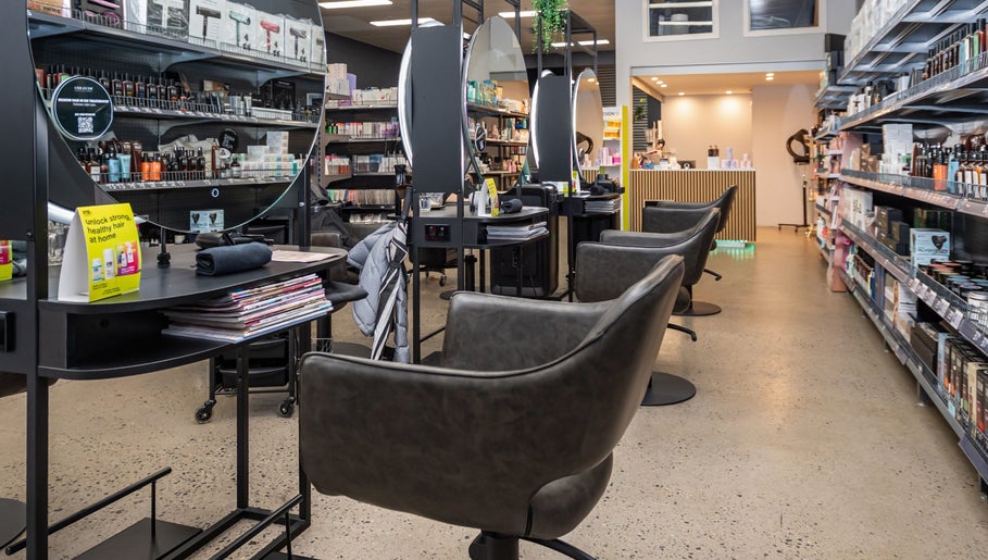 Modern salon interior at ATSI Hair Supplies, Brookvale, New South Wales, AU with styling stations and product shelves.