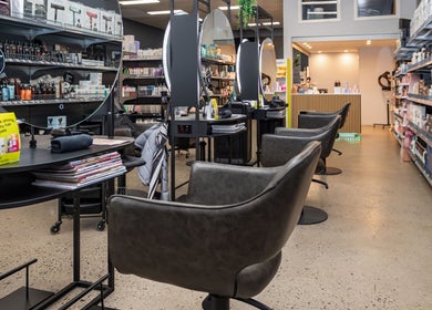 Modern salon interior at ATSI Hair Supplies, Brookvale, New South Wales, AU with styling stations and product shelves.