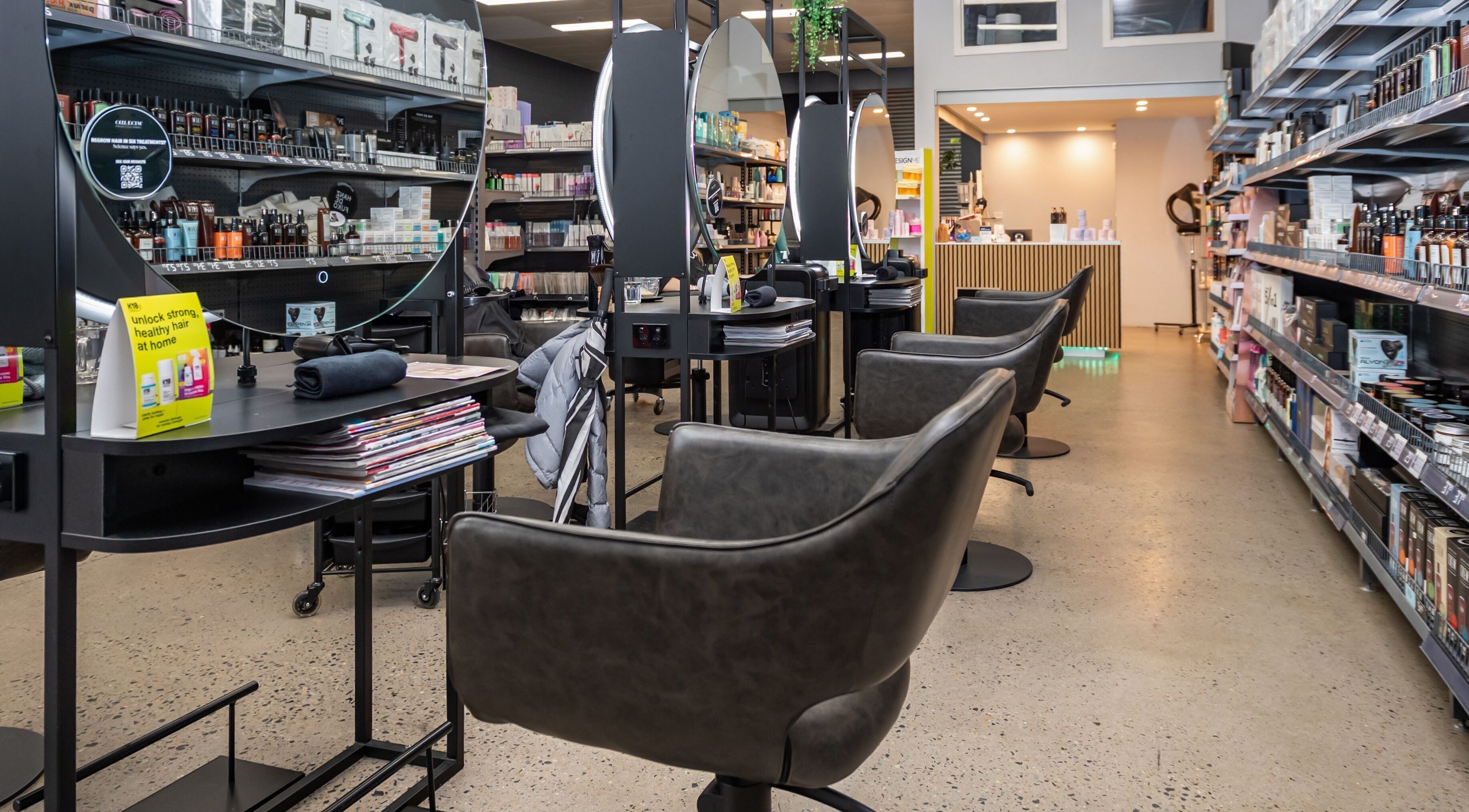 Modern salon interior at ATSI Hair Supplies, Brookvale, New South Wales, AU with styling stations and product shelves.