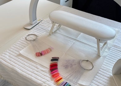 Professional nail setup at Leah Does Nails, Bredbury, England, GB showcasing colorful nail samples.