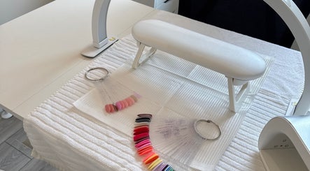 Professional nail setup at Leah Does Nails, Bredbury, England, GB showcasing colorful nail samples.