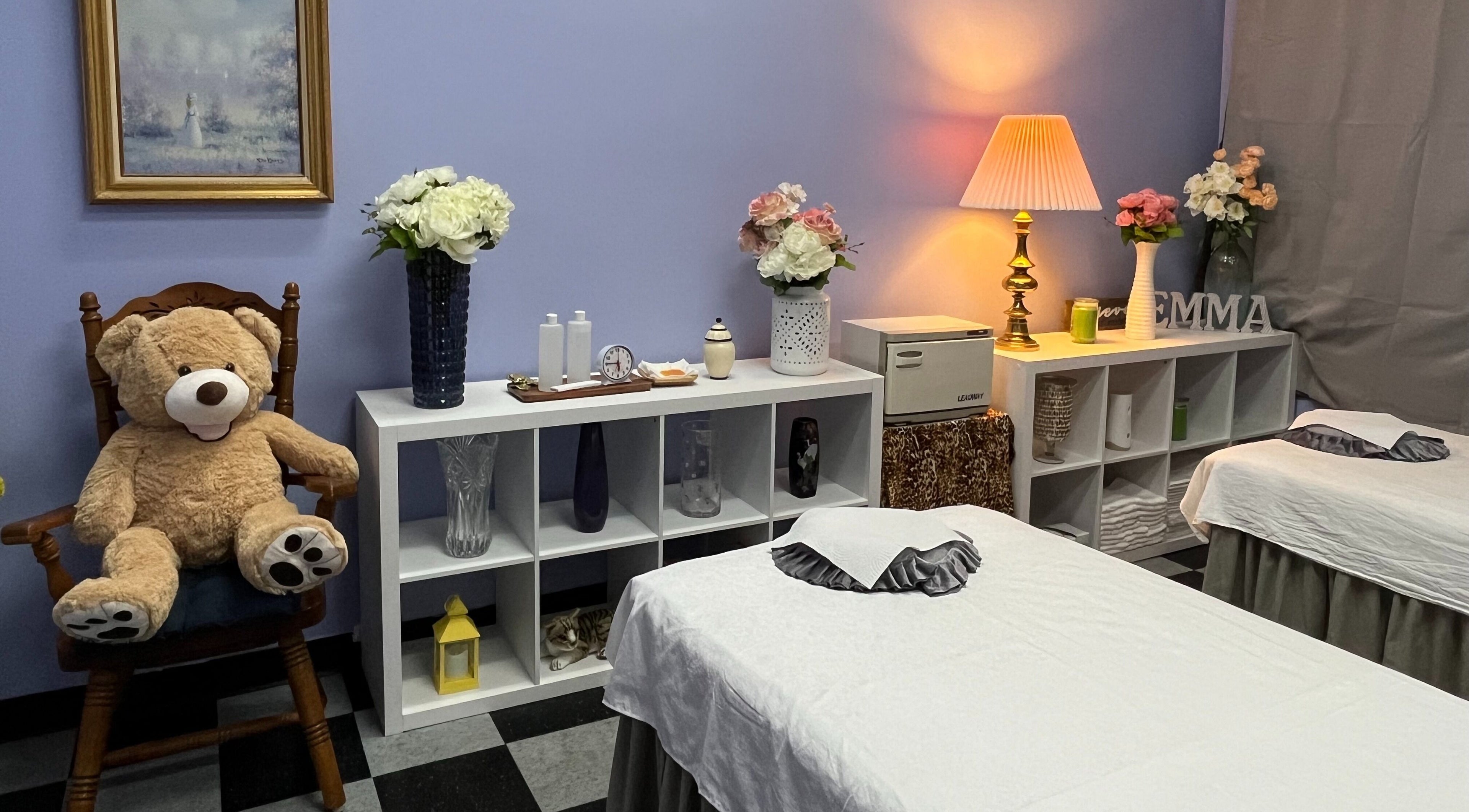 Inner view of Emma's Sunflower Spa, New Windsor, New York, US, featuring treatment tables and decor.