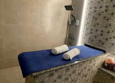 Luxurious treatment room at Al Shahid Salon in Dubai, Dubai, AE featuring a massage table and serene lighting.