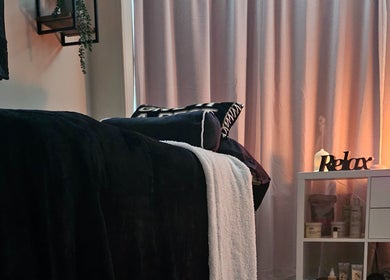 Tranquil therapy room at E R Beauty Therapy, Plymouth, England, GB, with soft lighting and relaxing decor.