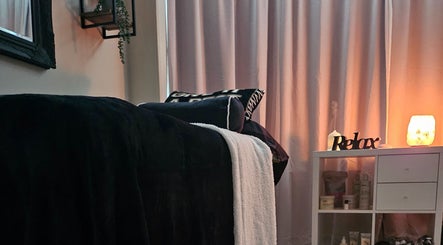 Tranquil therapy room at E R Beauty Therapy, Plymouth, England, GB, with soft lighting and relaxing decor.