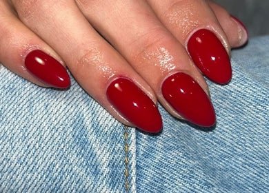 Vibrant red nails at BTS Beauty, Centurion, Gauteng, ZA, showcasing expert manicure skills.