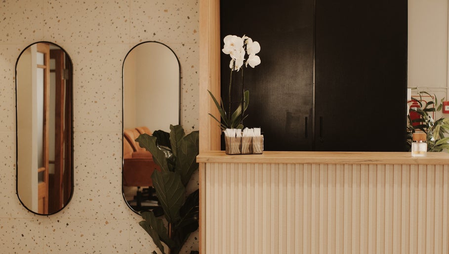 Reception area of BTS Beauty, Centurion, Gauteng, ZA with orchids and mirrors.