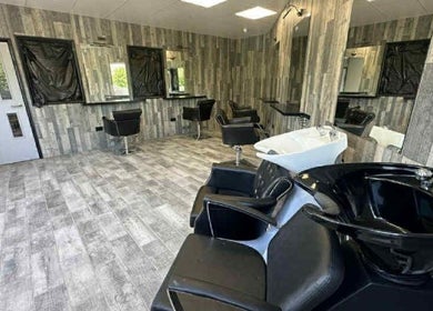 Modern hair salon interior at Kiera’s Kreations in Bognor Regis, England, GB, featuring sleek styling stations.