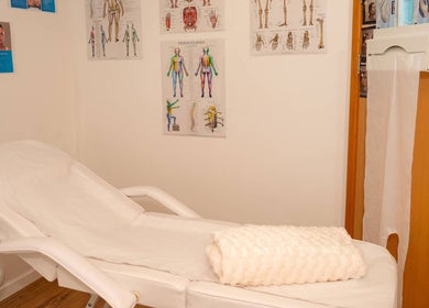 Comfortable therapy room at Ana Wellbeing, Luton, England, GB, featuring a plush treatment bed.