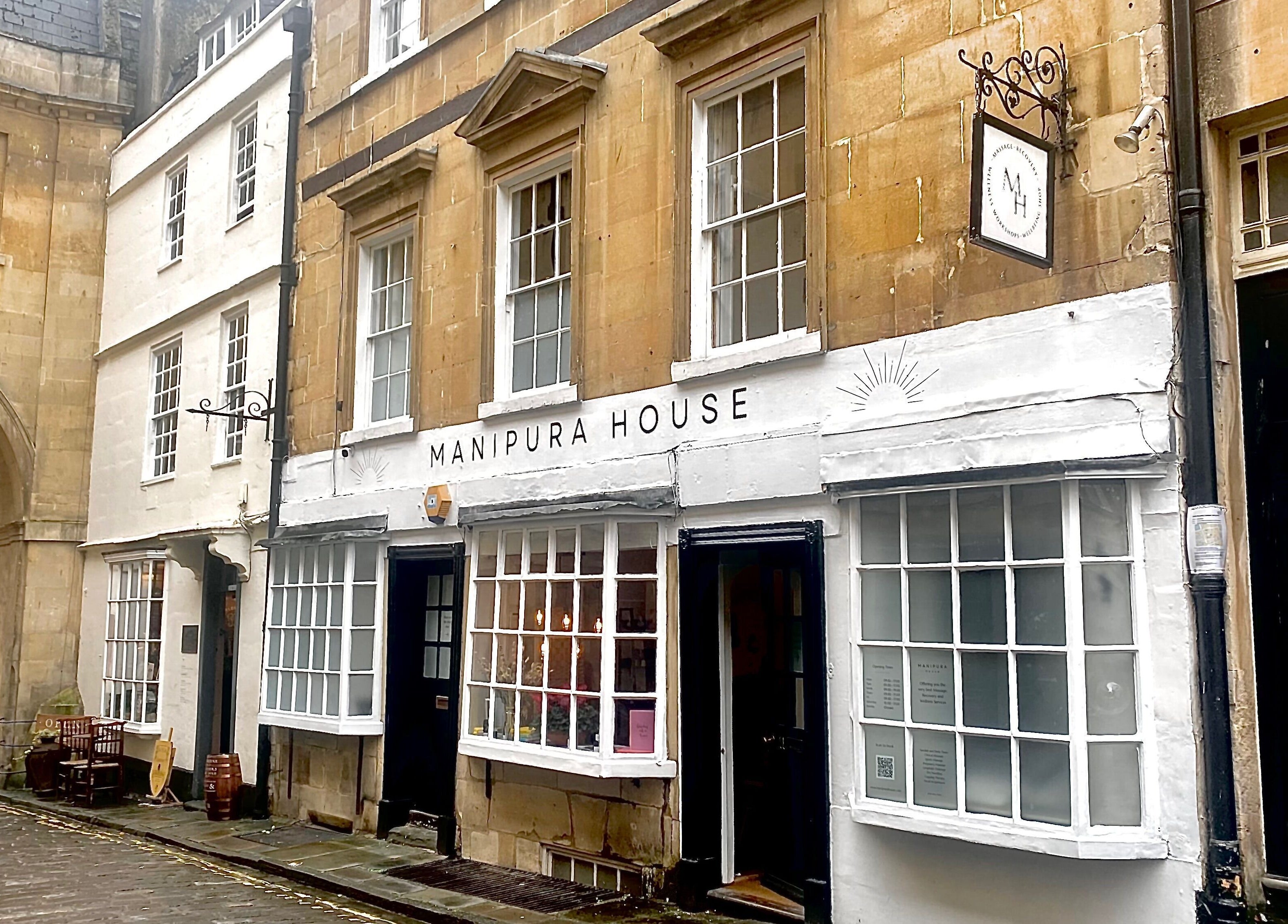 Street view of Manipura House, a beauty and wellness venue in Bath, England, GB, highlighting its elegant facade.