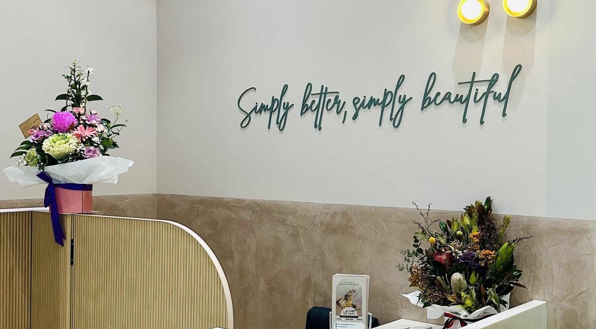 Milash Studio Hornsby reception with fresh flowers and a stylish wall sign in Hornsby, New South Wales, AU.