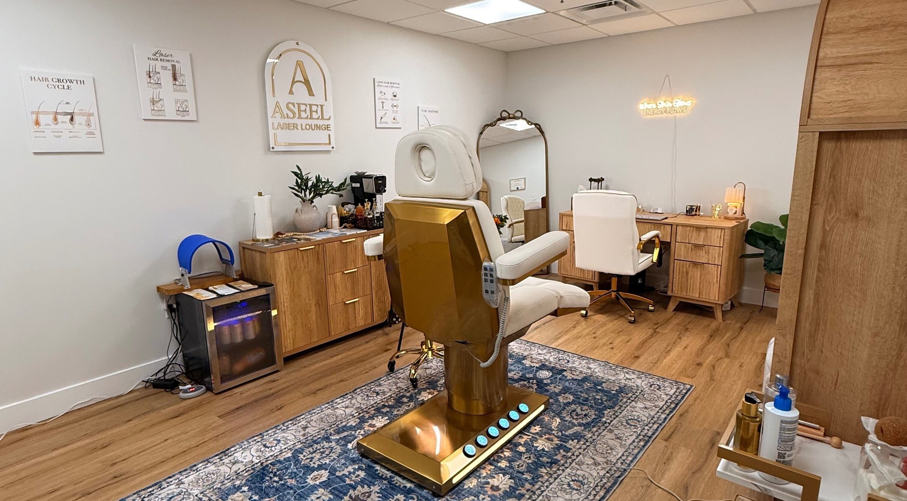 Elegant interior of Aseel Laser Lounge in Lexington, Kentucky, US features a luxurious gold chair and modern decor.