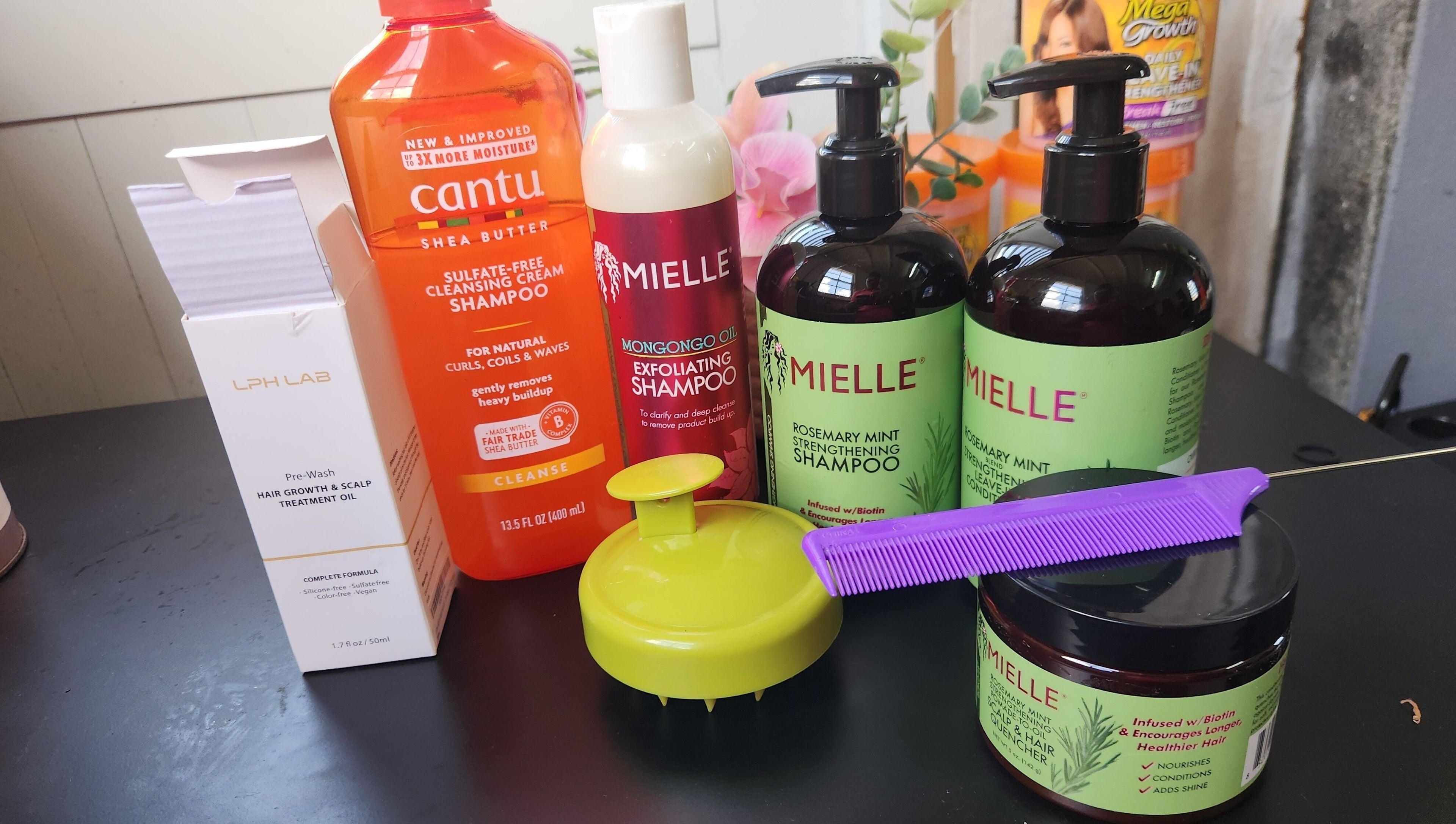 Assorted hair products at The Mane & Tame Haven, Dieppe Bay, KN, showcase for healthy hair care.