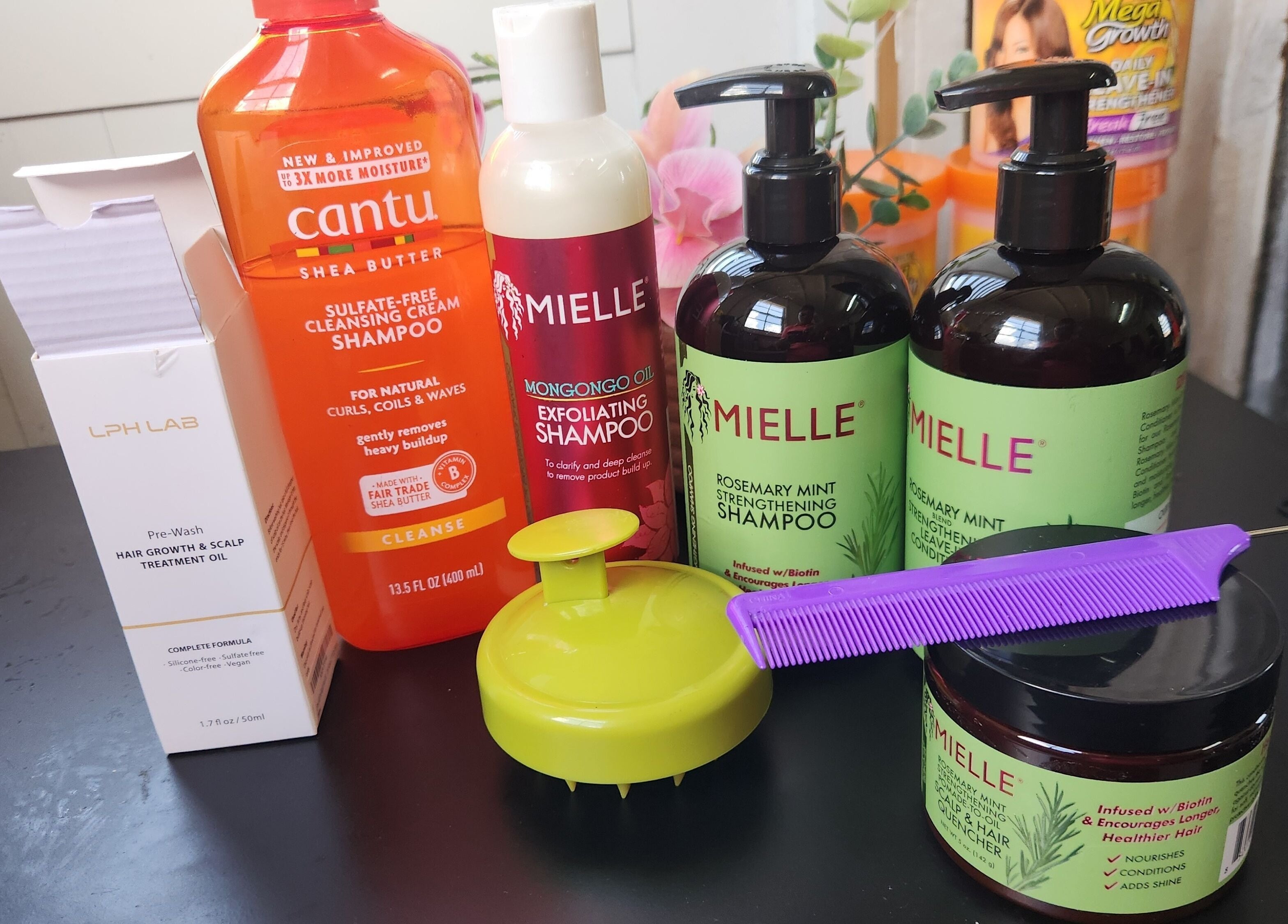 Assorted hair products at The Mane & Tame Haven, Dieppe Bay, KN, showcase for healthy hair care.