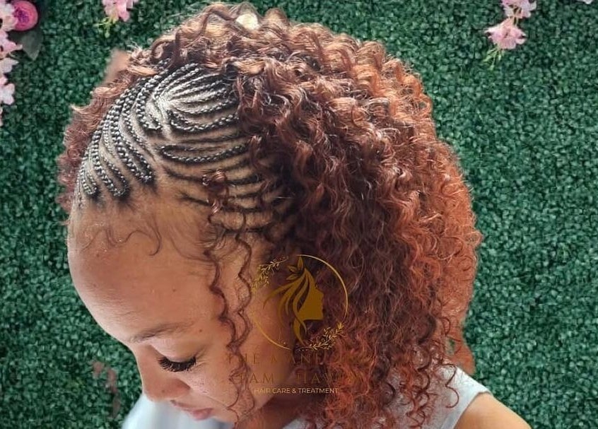 Intricate braided hairstyle at The Mane & Tame Haven, Dieppe Bay, KN, with lush backdrop.