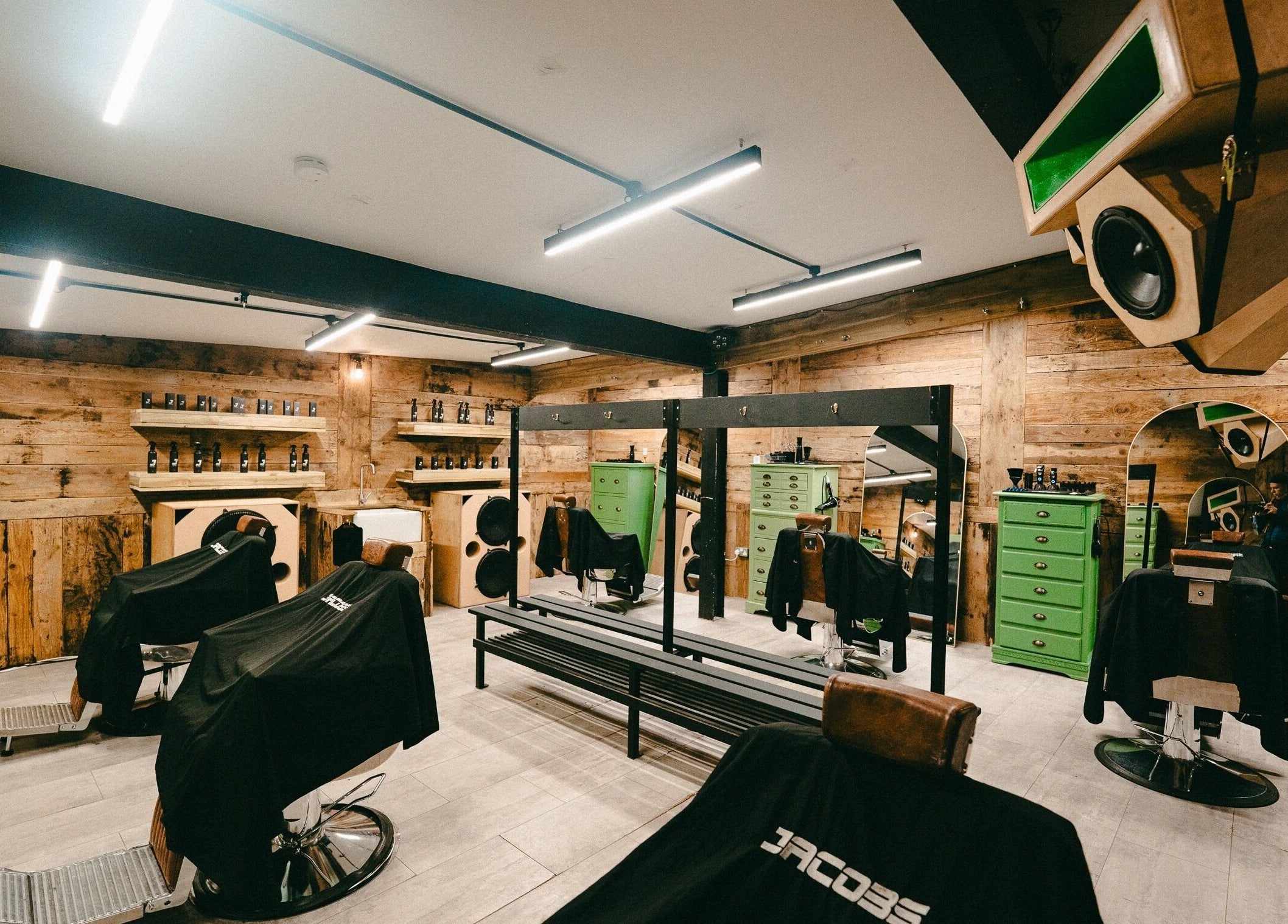 Interior of Jacobs Park Street barbershop in Bristol, England with rustic wood decor and modern styling chairs.