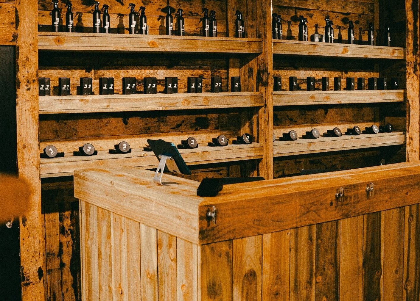 Rustic reception desk and shelves at Jacobs Park Street, Bristol, England, GB. Natural wood tones enhance the ambiance.