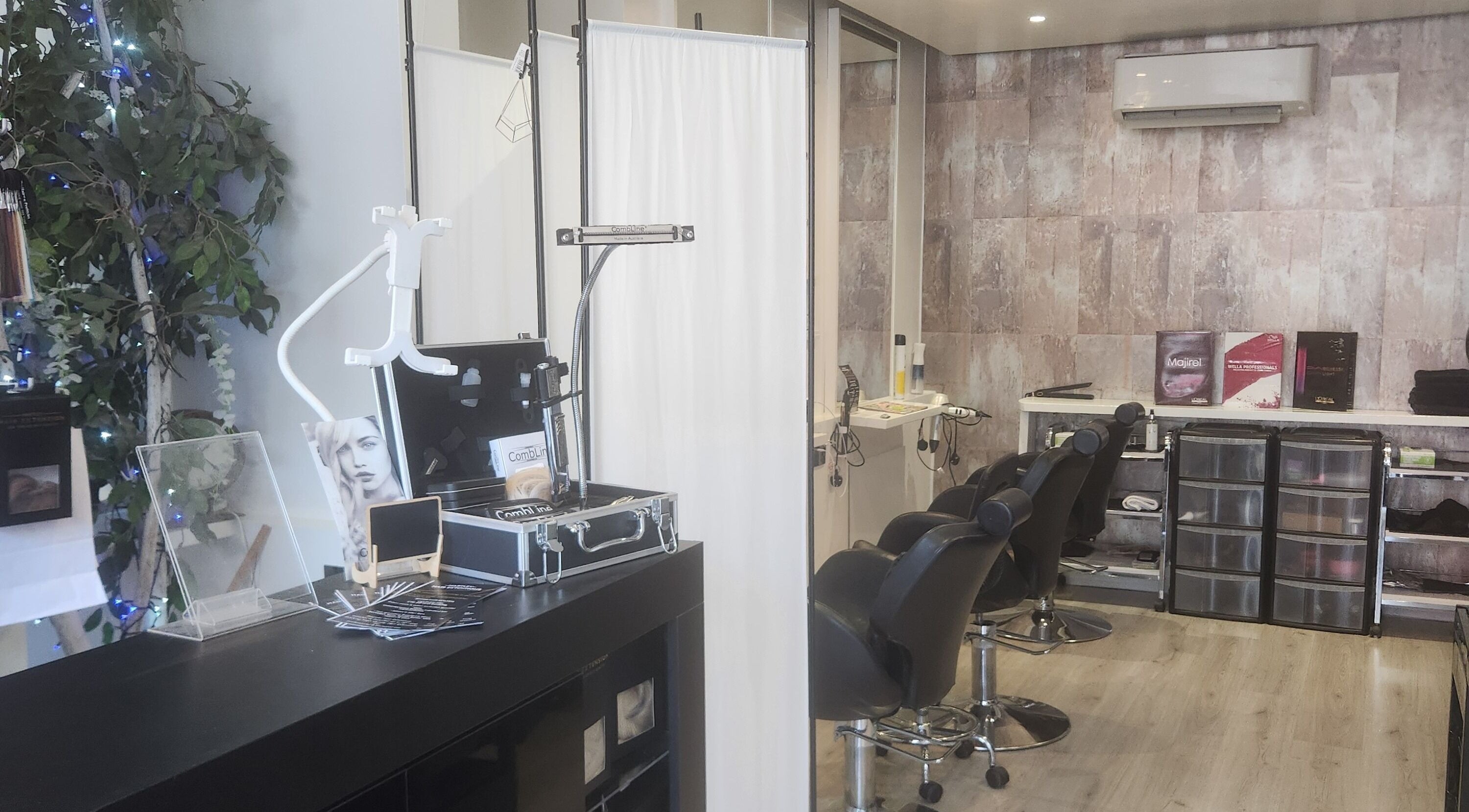 Chic interior of Hartley Mee Ltd, Southport, England, GB featuring salon chairs and beauty products.